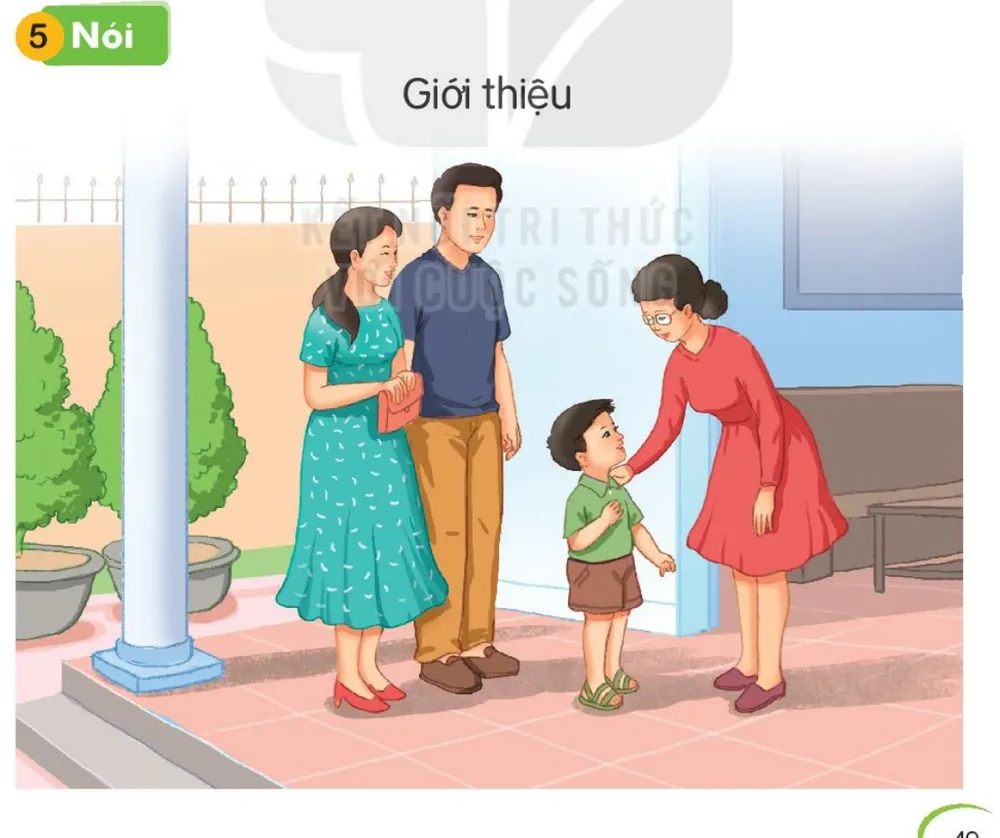 Bố mẹ đưa bạn nhỏ đến gặp một cô giáo ở cổng trường.