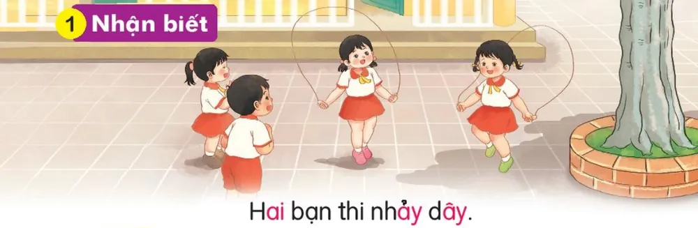 các bạn nhỏ nhảy dây ở sân trường. Câu dưới tranh: "Hai bạn thi nhảy dây."